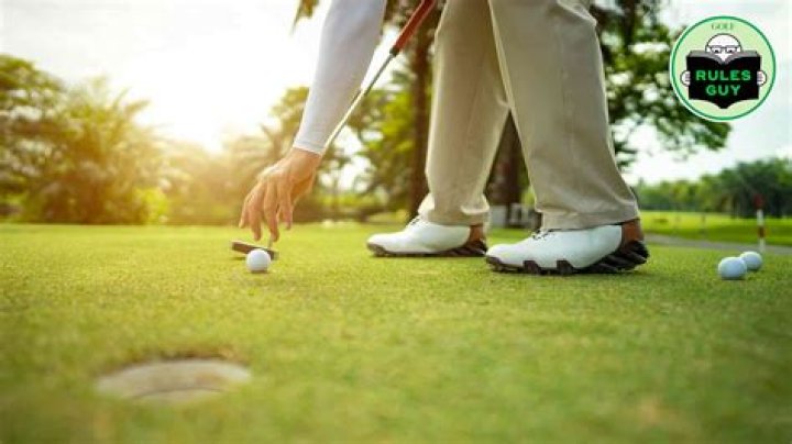 Can I touch my ball on the green?