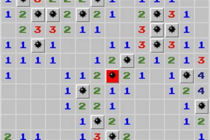 How do you reveal mines in Minesweeper?
