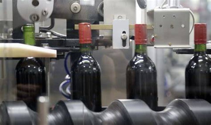 How do you sanitize corks before bottling wine?