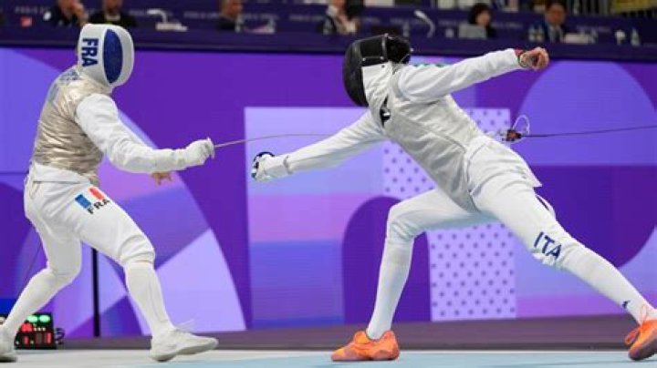 When was wireless fencing fully implemented Olympics?